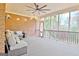 Large screened porch with furniture, brick wall, and outdoor view at 165 Hideaway Dr, Fayetteville, GA 30215