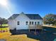 View of the back exterior showing the wood deck with railing and spacious backyard at 217 Point Ridge Ct, Temple, GA 30179