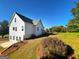 The back of the house features a deck with a large lot surrounded by mature trees at 217 Point Ridge Ct, Temple, GA 30179
