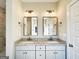 Bathroom featuring dual sinks, granite countertop vanity, and framed mirrors at 217 Point Ridge Ct, Temple, GA 30179