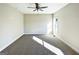 A spacious, sun-filled bedroom with plush carpet and fresh, neutral paint at 217 Point Ridge Ct, Temple, GA 30179