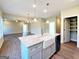 Kitchen island featuring granite countertops, a farm-style sink, and ample counter space at 217 Point Ridge Ct, Temple, GA 30179