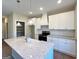 Kitchen featuring granite countertops, island sink, and ample storage space with a pantry at 217 Point Ridge Ct, Temple, GA 30179