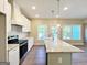 Open kitchen featuring granite counters, stainless appliances, and a central island with a farmhouse sink at 217 Point Ridge Ct, Temple, GA 30179