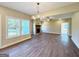 Bright living room featuring a brick fireplace and large windows overlooking the back yard at 217 Point Ridge Ct, Temple, GA 30179