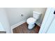 Bathroom featuring toilet and wood-look vinyl flooring at 217 Point Ridge Ct, Temple, GA 30179