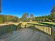 Wood deck showing expansive and lush backyard with mature trees along the property line at 217 Point Ridge Ct, Temple, GA 30179