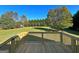 Backyard view from the wood deck showing lush lawn and tree line at 217 Point Ridge Ct, Temple, GA 30179