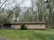 Back view of the house showcasing the backyard and the lush green surroundings of mature trees at 4389 & 4381 Campbell Rd, Snellville, GA 30039