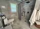 Renovated bathroom with gray tile shower, toilet, and window at 4389 & 4381 Campbell Rd, Snellville, GA 30039