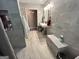 Modern bathroom featuring elegant gray tiling, floating sink, and recessed shelving at 4389 & 4381 Campbell Rd, Snellville, GA 30039