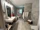 Updated bathroom with gray tile, floating sink, and modern fixtures at 4389 & 4381 Campbell Rd, Snellville, GA 30039