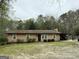 Charming single-story home featuring a covered patio and a classic brown exterior at 4389 & 4381 Campbell Rd, Snellville, GA 30039