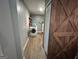 The laundry room has a washing machine, shelves, and a wooden barn door at 4389 & 4381 Campbell Rd, Snellville, GA 30039