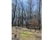 View of the wooded lot featuring a winding path through mature trees, ideal for nature walks and outdoor enjoyment at 4389 & 4381 Campbell Rd, Snellville, GA 30039