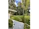 Lush backyard featuring stepping stones and mature trees creating a serene and private outdoor space at 497 Pine Haven Ln, Atlanta, GA 30342