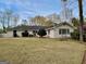 Spacious backyard with lush lawn, mature trees, and outdoor seating area at 497 Pine Haven Ln, Atlanta, GA 30342