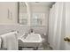 Well-lit bathroom featuring a pedestal sink, white tile, and walk in shower at 497 Pine Haven Ln, Atlanta, GA 30342