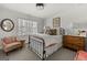 Cozy bedroom featuring a wrought iron bed frame and window with natural lighting at 497 Pine Haven Ln, Atlanta, GA 30342