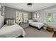 room with two twin beds, gray walls, and shelves for storage and display at 497 Pine Haven Ln, Atlanta, GA 30342