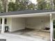 Spacious covered carport with ample storage and convenient access to the home's exterior doors at 497 Pine Haven Ln, Atlanta, GA 30342