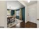 Dining room featuring hardwood floors, ample natural light, and stylish curtains that enhance the room's character at 497 Pine Haven Ln, Atlanta, GA 30342