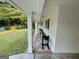 Covered side porch with bench seating offering a comfortable and shaded outdoor space to relax and enjoy the surroundings at 497 Pine Haven Ln, Atlanta, GA 30342