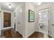 Inviting hallway with hardwood floors leading to a bathroom with pedestal sink at 497 Pine Haven Ln, Atlanta, GA 30342