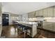 This open kitchen features stainless steel appliances, custom cabinetry, and a large island with seating at 497 Pine Haven Ln, Atlanta, GA 30342