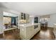 Bright kitchen featuring a large island with cooktop and quartz countertops open to the dining room at 497 Pine Haven Ln, Atlanta, GA 30342