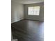 A cozy bedroom featuring hardwood floors and a window that lets in natural light at 6540 Lower Dixie Lake Rd, Union City, GA 30291