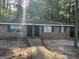 Brick multifamily home with a sidewalk leading to the front doors and green shutters surrounded by trees at 6540 Lower Dixie Lake Rd, Union City, GA 30291