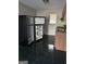 Functional kitchen features dark tile floors, a black refrigerator, wooden cabinets, and stainless steel sink at 6540 Lower Dixie Lake Rd, Union City, GA 30291