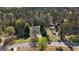 An aerial view of a home surrounded by mature trees in a beautiful well-kept neighborhood at 115 Brook Hollow Dr, Mcdonough, GA 30252