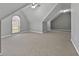 Large attic space with a ceiling fan and window providing ample natural light at 115 Brook Hollow Dr, Mcdonough, GA 30252