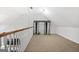 Spacious attic with carpeting and shelving unit offering ample storage space at 115 Brook Hollow Dr, Mcdonough, GA 30252