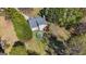 An aerial view of backyard showing the above-ground pool and patio with mature trees at 115 Brook Hollow Dr, Mcdonough, GA 30252