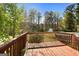 Wooden deck overlooks the private backyard surrounded by beautiful trees at 115 Brook Hollow Dr, Mcdonough, GA 30252