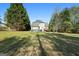 Spacious backyard featuring a home with neutral siding, an above ground pool, and mature trees at 115 Brook Hollow Dr, Mcdonough, GA 30252