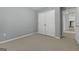 Simple bedroom with neutral color paint, carpeting, closet, and natural light at 115 Brook Hollow Dr, Mcdonough, GA 30252