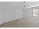Bedroom featuring carpeting, a window, a ceiling fan and closet for plenty of storage at 115 Brook Hollow Dr, Mcdonough, GA 30252