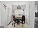 Bright dining room features light fixture, blind covered window and access to outdoors at 115 Brook Hollow Dr, Mcdonough, GA 30252