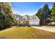 Beautiful home with brick and siding, complemented by mature trees and a well-kept lawn at 115 Brook Hollow Dr, Mcdonough, GA 30252