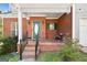 Inviting front porch featuring brickwork, a green door, and space for outdoor seating at 115 Brook Hollow Dr, Mcdonough, GA 30252