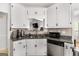 Bright kitchen features granite countertops, stainless steel appliances and white cabinets at 115 Brook Hollow Dr, Mcdonough, GA 30252