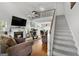 Spacious living room features a fireplace, high ceilings, and a staircase leading to a loft area at 115 Brook Hollow Dr, Mcdonough, GA 30252