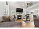 Bright living room with a fireplace, hardwood floors, and a vaulted ceiling with fan at 115 Brook Hollow Dr, Mcdonough, GA 30252