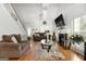 Inviting living room with hardwood floors, fireplace, and abundant natural light at 115 Brook Hollow Dr, Mcdonough, GA 30252