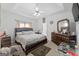 Bright bedroom features large bed, ceiling fan and access to attached bathroom at 115 Brook Hollow Dr, Mcdonough, GA 30252