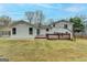 An expansive backyard with an exterior view of the home and a wood deck at 5155 Rosestone Nw Dr, Lilburn, GA 30047